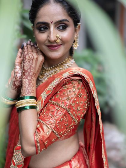 A candid style shot that shows the beautiful details of the saree's border and the bride's henna adorned hands.