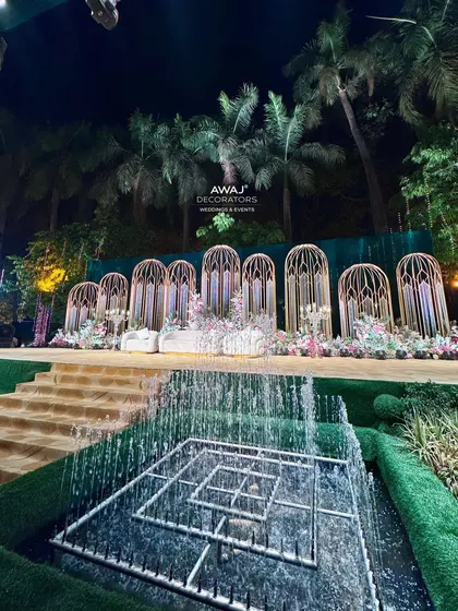 A wide view of the stage and fountains at night, with professional lighting creating a dramatic and unforgettable scene.