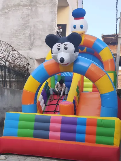 This is our 10x16 foot 2-slider bouncy, a great compact option that still offers multiple slides. It includes a climbing net and a fun Mickey and Donald character theme.