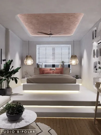 In another Wabi-Sabi inspired bedroom, we raised the bed on a two-step platform with integrated lighting, creating a distinct and elevated sleeping nook. The ceiling features a pink textured paint, adding a soft pop of color.