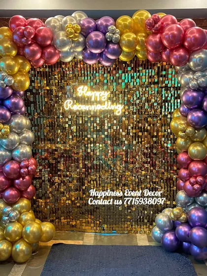 Sequin backdrops are very popular for adding glamour to any party. Here is a gold sequin wall framed by a multi-colored balloon garland and a custom neon sign, creating a vibrant photo corner.