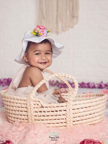A sweet girl in a wicker basket, surrounded by a field of flowers. This shows how we use different props and textures to create beautiful scenes.