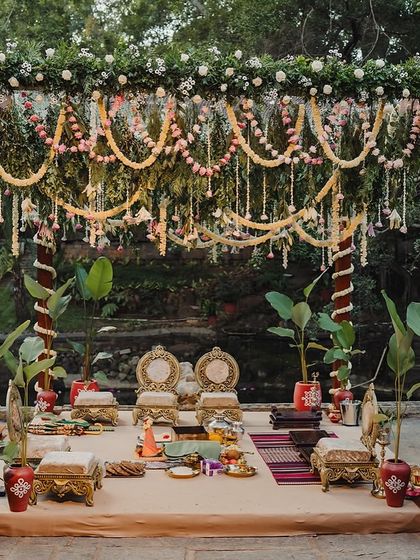 A traditional mandap setup by the pond, complete with brass vessels, seating, and floral decorations.