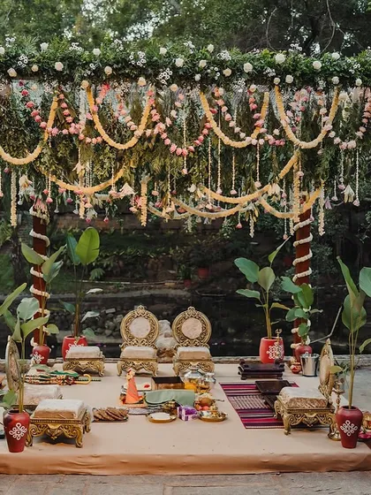 A mandap decorated for a cross-cultural wedding, blending South Indian floral elements with a unique structural design.