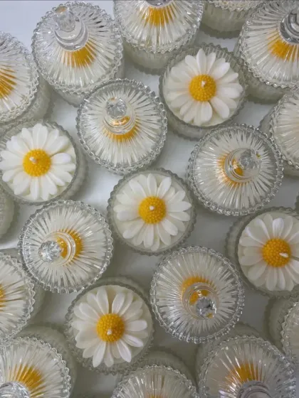 An overhead view of the daisy jar candles, showing them with their lids on.