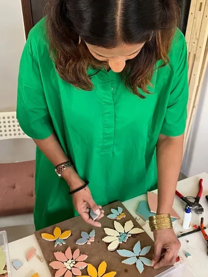 A sneak peek from my phone gallery. Here I am working on a mosaic project, arranging ceramic flower pieces. I love exploring art in all its forms.