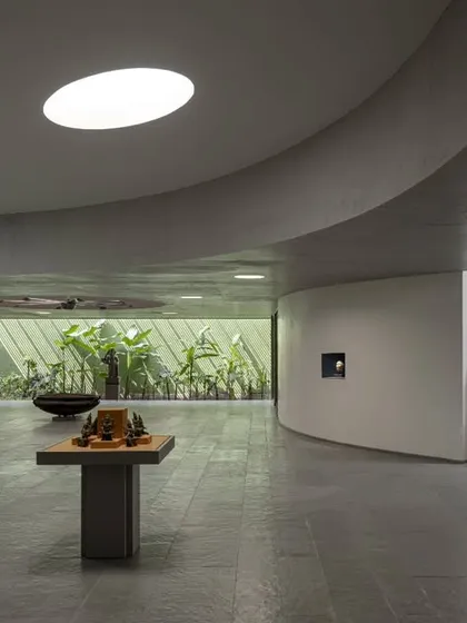 The interior of the Vismaya museum is a fluid, open-plan space modulated by curving walls and carefully controlled light from above. This allows for a flexible arrangement of artifacts and creates a varied journey for the visitor.