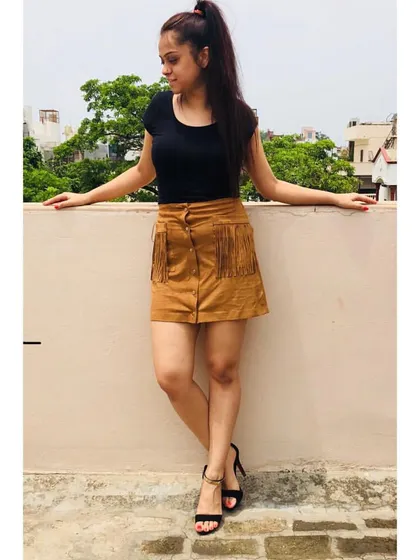 A simple black top paired with a statement suede skirt with fringe details makes for a stylish weekend look. It's all about balancing basic pieces with more unique items to create interest.
