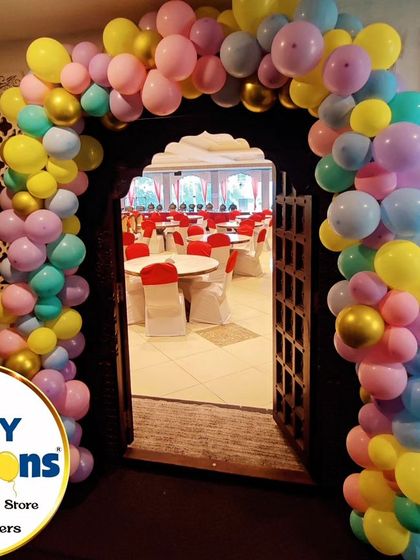 A welcoming balloon arch for a Cocomelon-themed party, with a pastel color palette.
