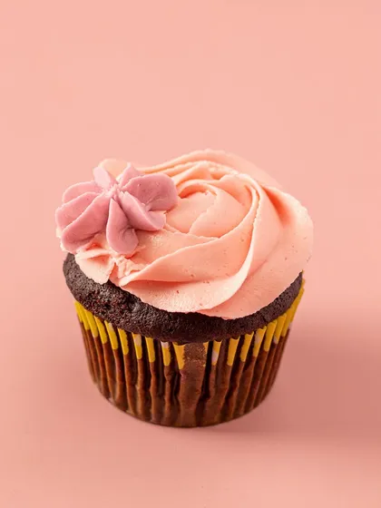 A single, elegant cupcake with a moist Belgian chocolate base and a perfect swirl of pink vanilla buttercream. Sometimes, simplicity is the ultimate sophistication.