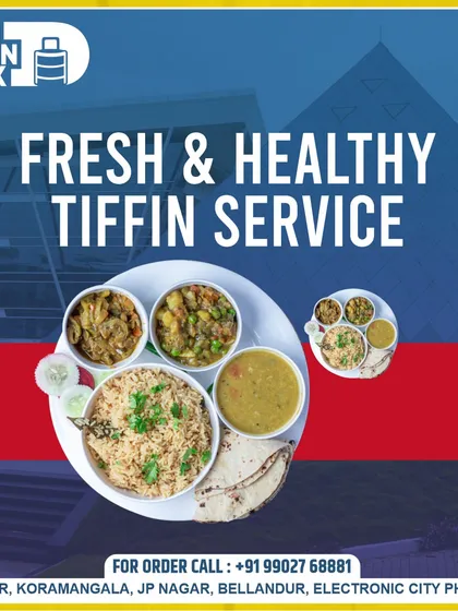Our fresh and healthy tiffin service is designed for the modern workplace. This image shows our standard meal plate against an office building backdrop, highlighting our focus on corporate meal delivery.