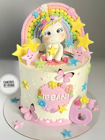 A cheerful unicorn cake for Ibbani's 6th birthday. This design is full of happy details, including a cute fondant unicorn, smiling stars, and a pastel rainbow made of tiny sugar balls.