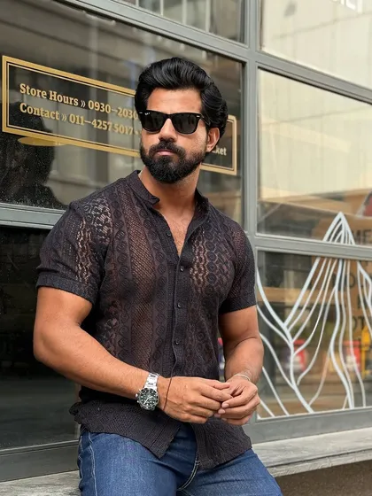 For the bold and fashion-forward gentleman, our knitted mesh fabric shirt in sleek black. This piece is designed to make a statement.