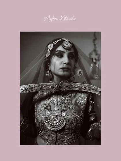 Another powerful shot through the veil, this time in black and white. It creates a dramatic and timeless bridal portrait, focusing on the bride's eyes and the intricate details of her attire.