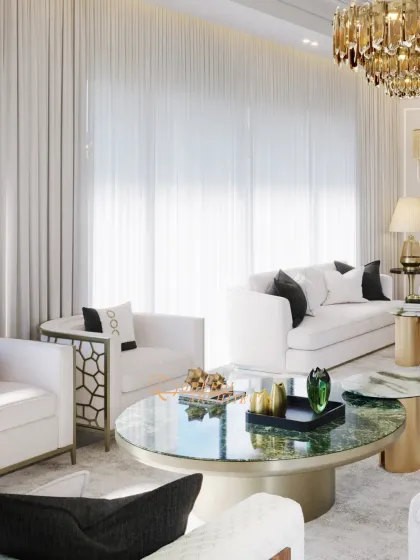 This space embodies the essence of a serene white palette. Soft textures, gold accents, and a stunning green marble coffee table create a harmonious balance of luxury and tranquility.