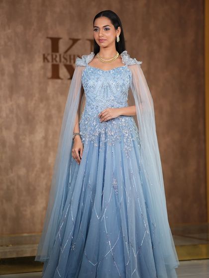 A modern, fashion-forward look featuring a pearl-encrusted gown. The simple diamond drop earrings are the perfect accessory for this statement outfit.