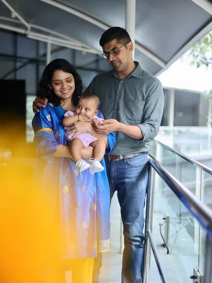 A young family shares a sweet moment with their baby. The soft, natural light in this photo creates a gentle and loving mood.