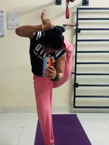 A deep hip-opening stretch in Durvasasana. This pose requires immense flexibility and is a testament to what the body can achieve with practice.