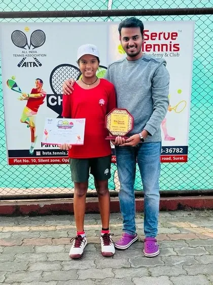 Tamanna with her brother, also a player, celebrating her singles victory in Surat.