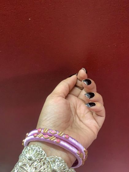 A collection of my pink silk thread bangles, showcasing a variety of designs from simple geometric patterns to elaborate floral kundan work.