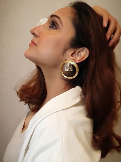 Another angle of me wearing the large brass and crystal hoop earrings, showing how they catch the light.