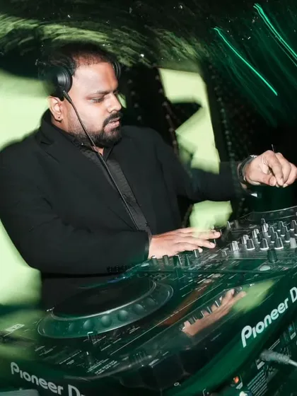 In the zone under the green lights of a wedding reception. My focus is on reading the crowd and selecting the right track at the right moment to maintain the party's momentum.