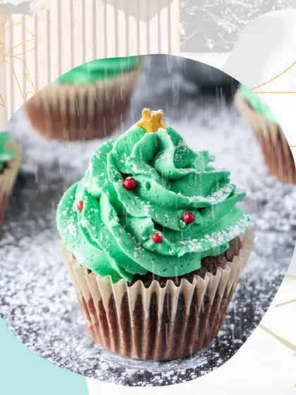 A single Christmas tree cupcake, topped with beautifully piped green frosting and a star. A light dusting of powdered sugar gives it a magical, snowy effect, perfect for getting into the holiday spirit.