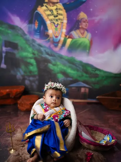 Another beautiful portrait from the Ekvira Aai themed shoot, capturing the baby's innocent and curious expression.