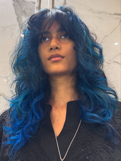 A still shot of the vibrant blue hair color, showing the beautiful, rich tones and modern, shaggy haircut.