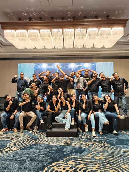 A fun, candid moment with the whole crew after a successful event. This picture perfectly captures the playful and supportive spirit of our AnD family.