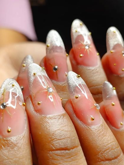 A close-up shot of the star-dusted nails, highlighting the delicate rhinestone and bead work.