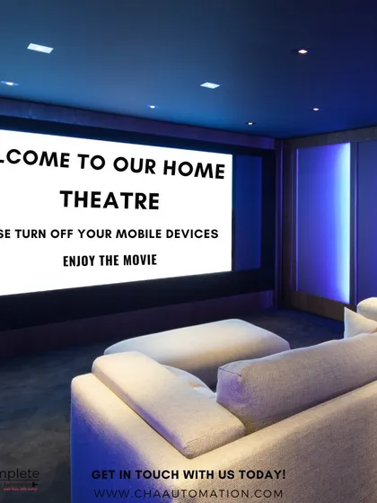 This is what a fully integrated home theatre looks like. We manage every detail, from the ambient blue accent lighting to the high-definition screen, creating a sophisticated and automated entertainment space.