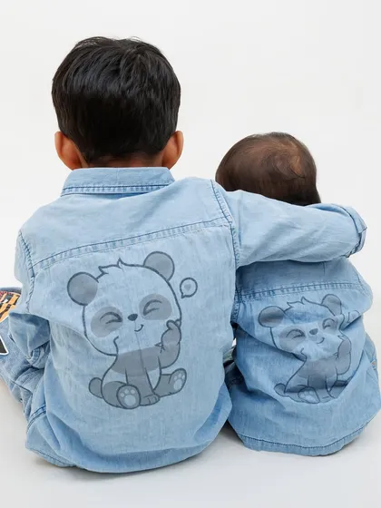 Sometimes the best shots are the ones you don't plan. This photo of the brothers' matching panda shirts shows a cute detail that adds personality to their sibling portrait session.