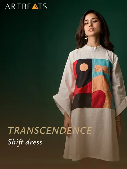 A studio shot of the Transcendence shift dress. The clean lines and bell sleeves create a modern silhouette, while the abstract artwork serves as a powerful focal point.