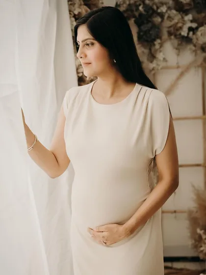 A simple and elegant portrait taken in our versatile studio space. The neutral tones and soft lighting create a timeless look that focuses purely on the mother-to-be.
