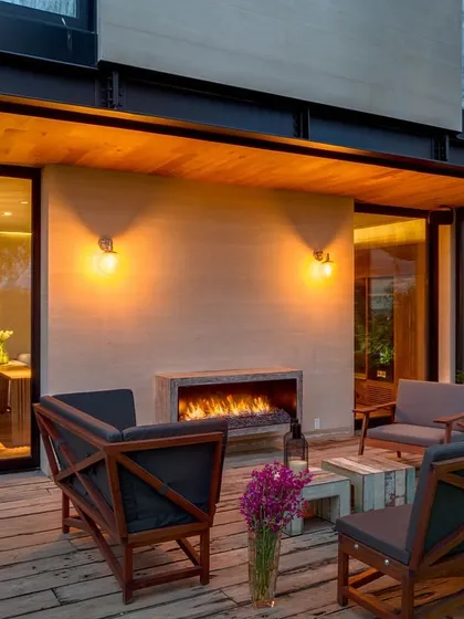 A backyard that balances structure with nature. The minimal design has a rustic edge, featuring a modern fireplace and comfortable seating, creating a space that feels grounded and inviting.