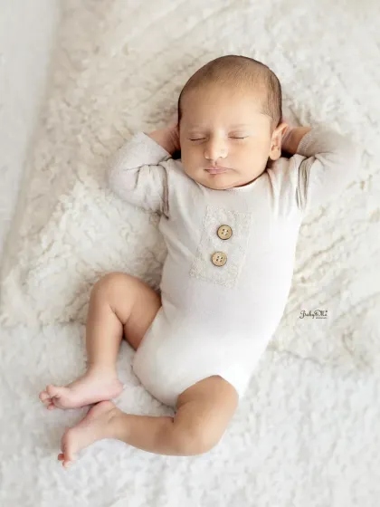 This little one is relaxing like a boss. It's amazing the little personalities you see, even when they're fast asleep. This was captured on a simple, soft blanket to keep the focus on him.