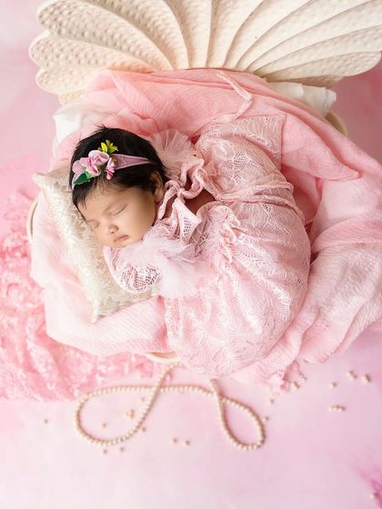 Your baby is a precious pearl, and this setup brings that idea to life. Nestled in a beautiful seashell prop, this little one is the definition of a hidden treasure.