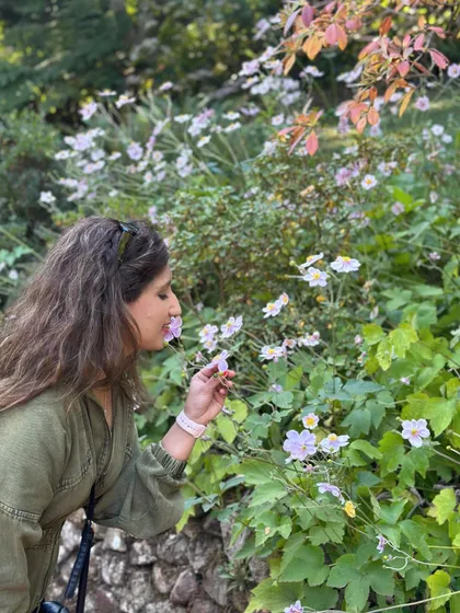 Pausing to smell the flowers. It's a simple act of mindfulness that helps you connect to the present moment and appreciate the small beauties in life.