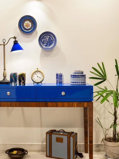 Every home has a piece that steals the show. In Ridge View, it's this deep blue console. A bold nod to the client's love for color, it anchors the space while housing an eclectic mix of books, art, and travel finds.