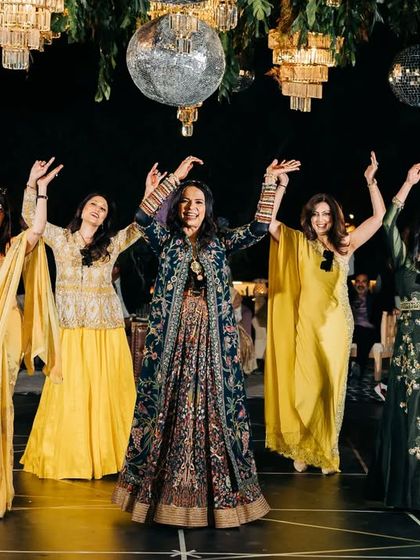 The mother of the bride leading a beautiful group performance at a Jaisalmer destination wedding. The entire sangeet was choreographed via video tutorials for the family based in the USA.
