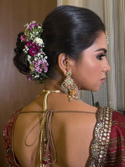 A detailed shot from the back, showing the full glory of the textured bun and its floral arrangement.
