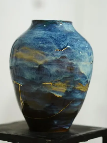 This vase features a beautiful, flowing glaze that reminds me of a landscape, with touches of gold kintsugi to celebrate its unique journey and imperfections.