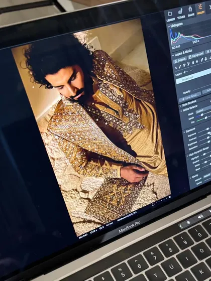 A behind the scenes glimpse of the final shots on the monitor. This shows the immediate result of the grooming work as seen through the photographer's lens during a men's fashion shoot.