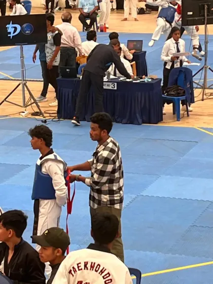 A behind the scenes look at a competition, where coaches and teammates help prepare a fighter for their match.