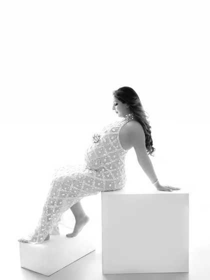 A high-key, black and white portrait in a sequined gown, creating a look that is both modern and timelessly elegant.