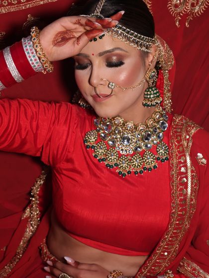 This image captures the soft, romantic side of a bridal look. With eyes gently closed, you can appreciate the smooth blending of the eyeshadow and the flawless, airbrushed finish on the skin.