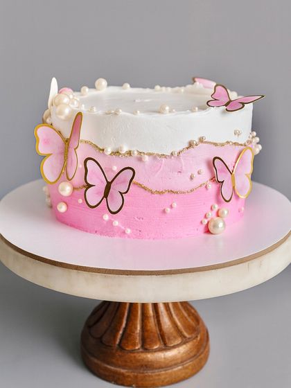 This dreamy fault line cake is dressed in butterflies and pearls, making it perfect for a special birthday or celebration. Inside, it’s loaded with fresh fruits, creating a dessert that is as delicious as it is beautiful.