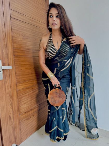 Another angle of this gorgeous client in our black and gold halter blouse. It's the perfect look for a Diwali party or a cocktail event.