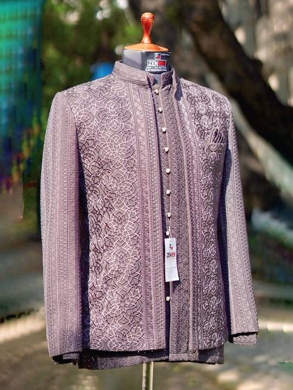 The same mauve-brown Jodhpuri suit, seen from a slightly different angle. The subtle shimmer of the fabric and the detailed texture are visible here.